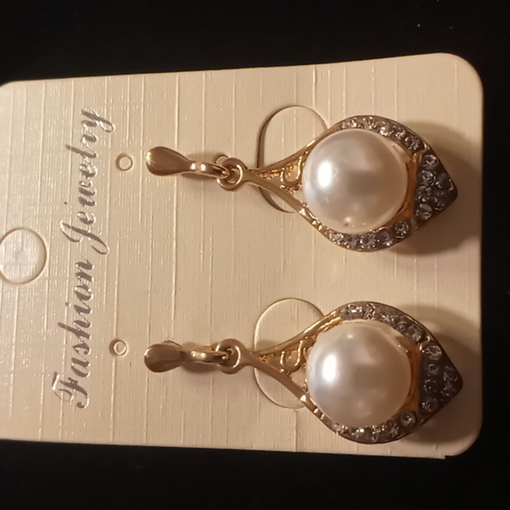 Gold tone drop faux pearl earrings.
